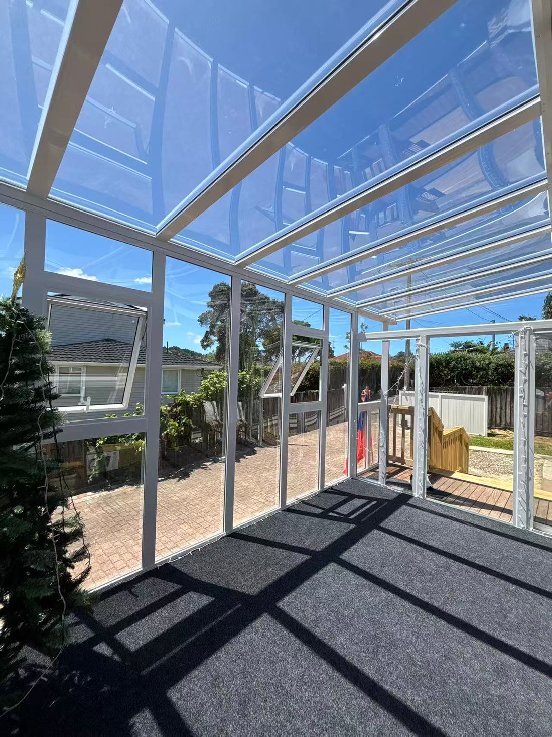 Glass sunroom and modern aluminium canopy installed on a Christchurch house deck