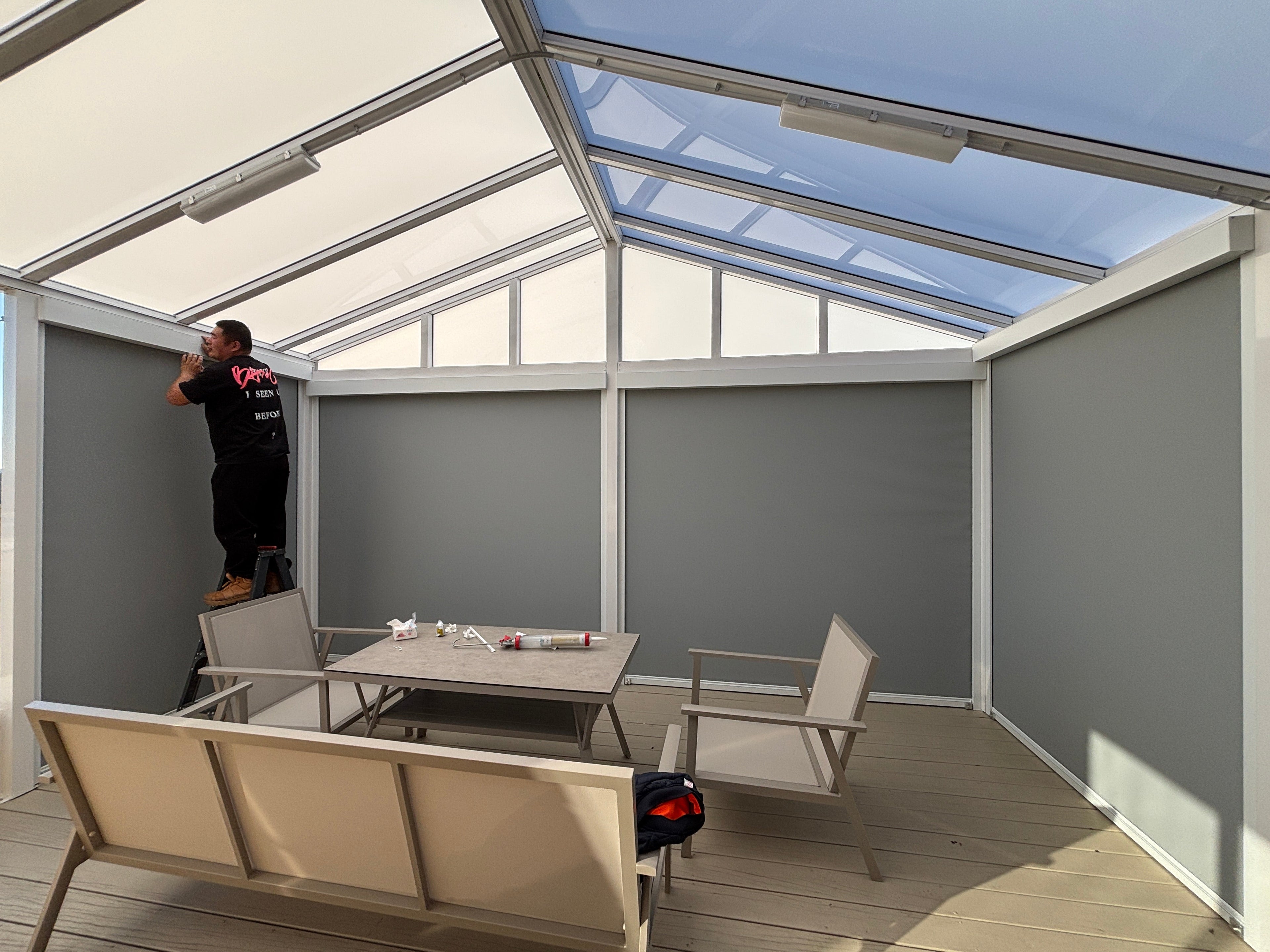 Custom black architectural aluminium ridge gable pergola with louvre roof on a modern New Zealand home deck